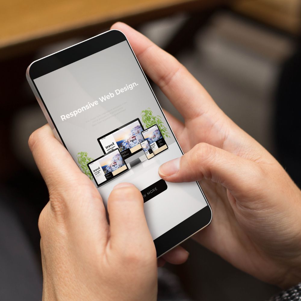 Person holding a smartphone displaying responsive web design examples — illustrating the importance of mobile-first, affordable vs cheap website development.